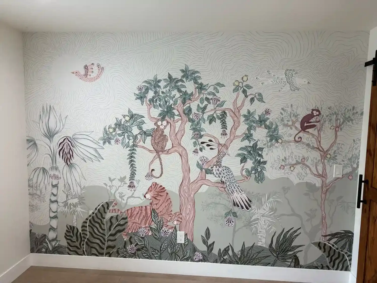 A colorful botanical wallpapered wall anchoring a sitting area